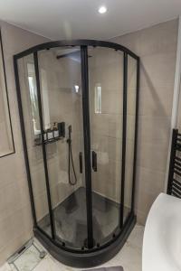 a shower with a glass enclosure in a bathroom at Oasis Retreat Hot Tub Cupar in Cupar +38 photos