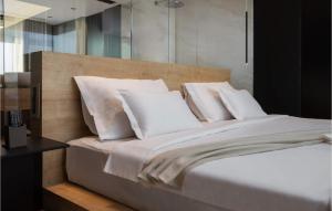 a bedroom with a large bed with white pillows at Villa Soiree in Starigrad
