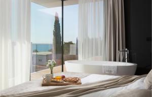 a bedroom with a tub and a tray of food on a bed at Villa Soiree in Starigrad