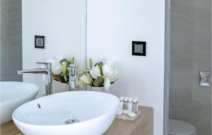 a bathroom with a white tub and a sink at Villa Soiree in Starigrad