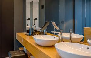 a bathroom with two white sinks and a mirror at Villa Soiree in Starigrad +33 photos