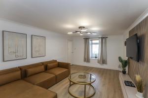 a living room with a couch and a table at Oasis Retreat Hot Tub Cupar in Cupar
