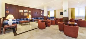 a lobby with chairs and tables and a waiting room at Globales Almirante Farragut in Cala en Blanes