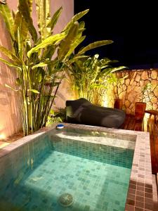 una pequeña piscina con plantas en un patio trasero en Casa Nina Milagres, en São Miguel dos Milagres