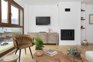 a living room with a table and a chair at Casa Mia by BeValle in Panticosa