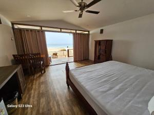 a bedroom with a bed and a view of the ocean at Agonda Beach Villa in Agonda