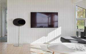 a living room with a tv on the wall at Gorgeous Home In Or With Kitchen in Orø