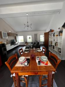 a dining room with a wooden table and chairs at Borgo Lungofiume B&B in Valbrenta 