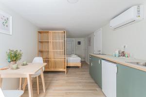 a kitchen with a table and a dining room at Studio1 Van Lerius in Antwerp