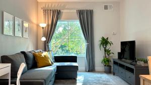 a living room with a couch and a window at HSO - Family Apartments Close to Disney World & Universal in Orlando