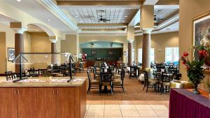 a restaurant with a lot of tables and chairs at HSO - Family Apartments Close to Disney World & Universal in Orlando