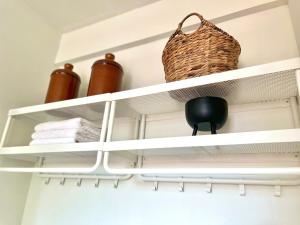 a shelf in a bathroom with towels and a basket at IKO homes in Kota Kinabalu
