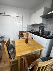 a kitchen with a wooden table and a table and chairs at Flat in London in London