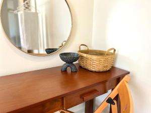a table with a mirror and a basket on it at IKO homes in Kota Kinabalu