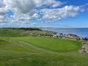 un campo de golf con el océano en el fondo en Cliffside en Lossiemouth