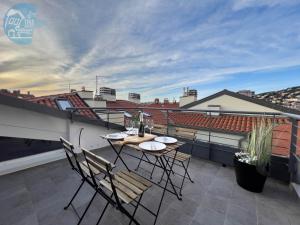 a patio with a table and chairs on a balcony at Tarabochia 8 Tirabora Short Rent in Trieste