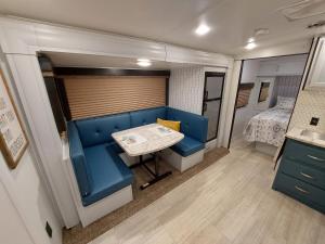 a dining room with a table in a rv at The Torres' Camper Experience! in Tampa