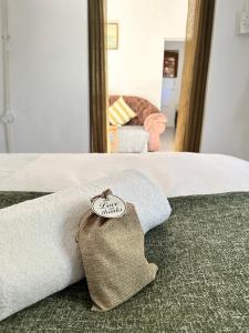 a hotel room with a towel on a bed at Swinburn’s Rest in Lobatse