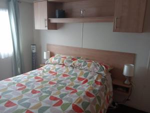 a bedroom with a bed with a colorful quilt at 19 Chaffron in Hull