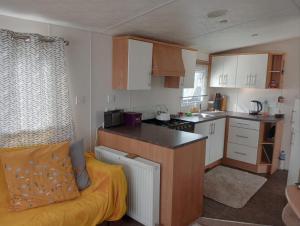 a kitchen with a couch in a small room at 19 Chaffron in Hull