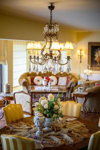 a dining room with a table and a chandelier at Senso Panorama Villa and Suite in Kalamata +171 photos