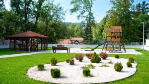 a park with a playground and a swing at SZKLARSKA VIEW Luxury Apartment Jacuzzi in Szklarska Poręba