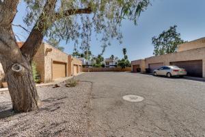 a tree and a car parked in a parking lot at Pet-Friendly Casa Grande Townhome Screened Atrium in Casa Grande