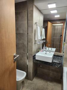 a bathroom with a sink and a toilet and a mirror at Casita de Tucumán - Santiago in San Miguel de Tucumán