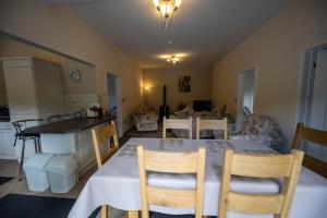 a kitchen and dining room with a table and chairs at The New Larches in Bewdley