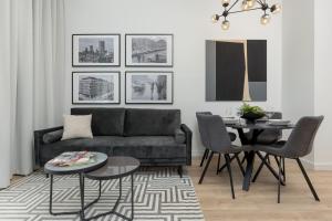 a living room with a couch and a table at Warsaw City Center Apartments by Renters in Warsaw