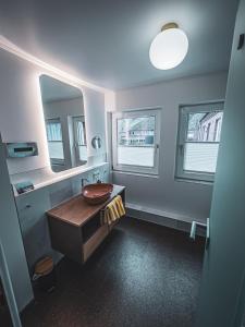 a bathroom with a sink and a mirror at Restaurant Hotel Goldener Adler in Emden