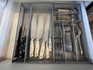 a drawer filled with knives and utensils at The Evergreen House in Red Deer