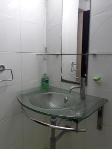a bathroom with a glass sink and a mirror at A MODERN APARTMENT FOR YOU in Nicosia