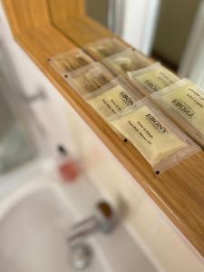 a wooden shelf above a bathroom sink with soap at Ashton Gate Mews in Bristol