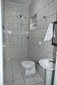 y baño con aseo y lavamanos. en Villagio Vistamar Ilha Comprida, en Ilha Comprida