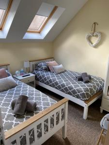 a bedroom with two beds and a heart sign on the wall at Ashton Gate Mews in Bristol