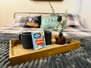 a tray with two cups of coffee and a box of cereal at Acorn Hideaways Canton Secluded Sherlock Holmes Suite King Bed in Canton