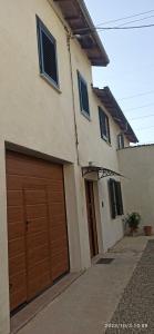 a house with two garage doors in a driveway at VILLA VIOLA B & B in Baganzola