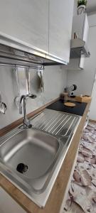 a kitchen counter with a sink in a kitchen at Casa Nanuzza in Naples +37 photos