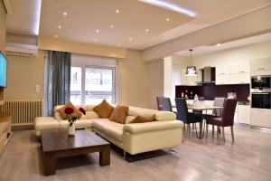 a living room with a couch and a table at Gtrip Piraeus Floor Apartment - 8324 in Piraeus
