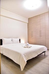 a bedroom with a large white bed with white pillows at Gtrip Piraeus Floor Apartment - 8324 in Piraeus