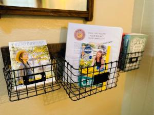 a towel rack with books and magazines on a wall at Acorn Hideaways Canton Unwind at Green Gables Suite for up to 3 in Canton