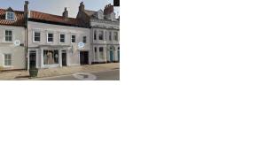 a picture of a building and a picture of a street at Apartment22. A stylish and spacious Apartment in the heart of Historic Market town of Beverley. in Beverley