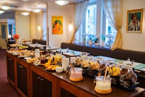 a buffet line with food and drinks on it at Hotel U Divadla in Prague