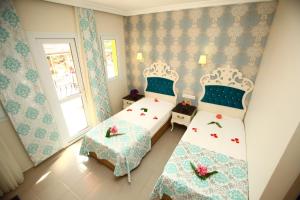 Postel nebo postele na pokoji v ubytování Turk Hotel