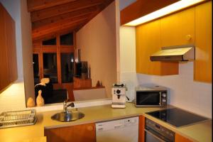 a small kitchen with a sink and a window at Crap da Flem - 3.5 Zimmer Ferienwohnung am Sonnenhang von Flims in Flims