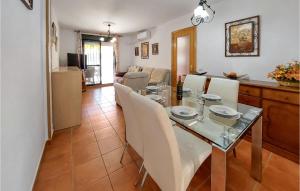 a dining room and living room with a table and chairs at Cozy Apartment In Chiclana De La Front, With Kitchen in Novo Sancti Petri