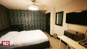 a hotel room with a bed and a tv at Shut Eyes in London