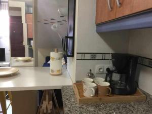 a kitchen with a counter with cups and a coffee maker at Asturias Boho Chic in Aller