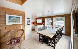 a dining room with a wooden table and chairs at Stunning Home In Nord Torpa With Wifi in Nord Torpa